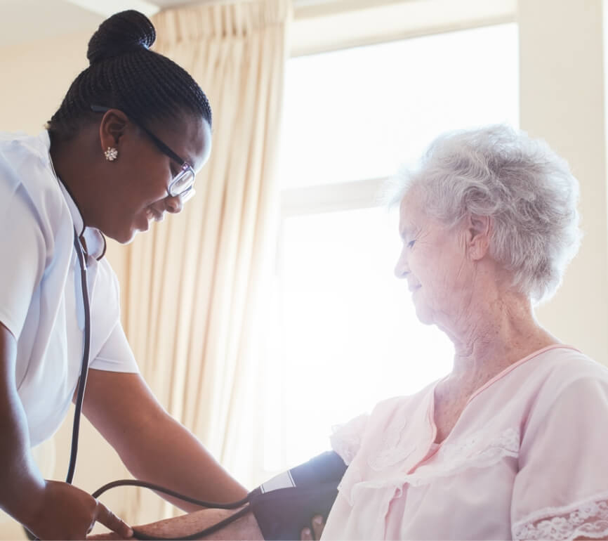 nurse helping patient with blood pressure cuff