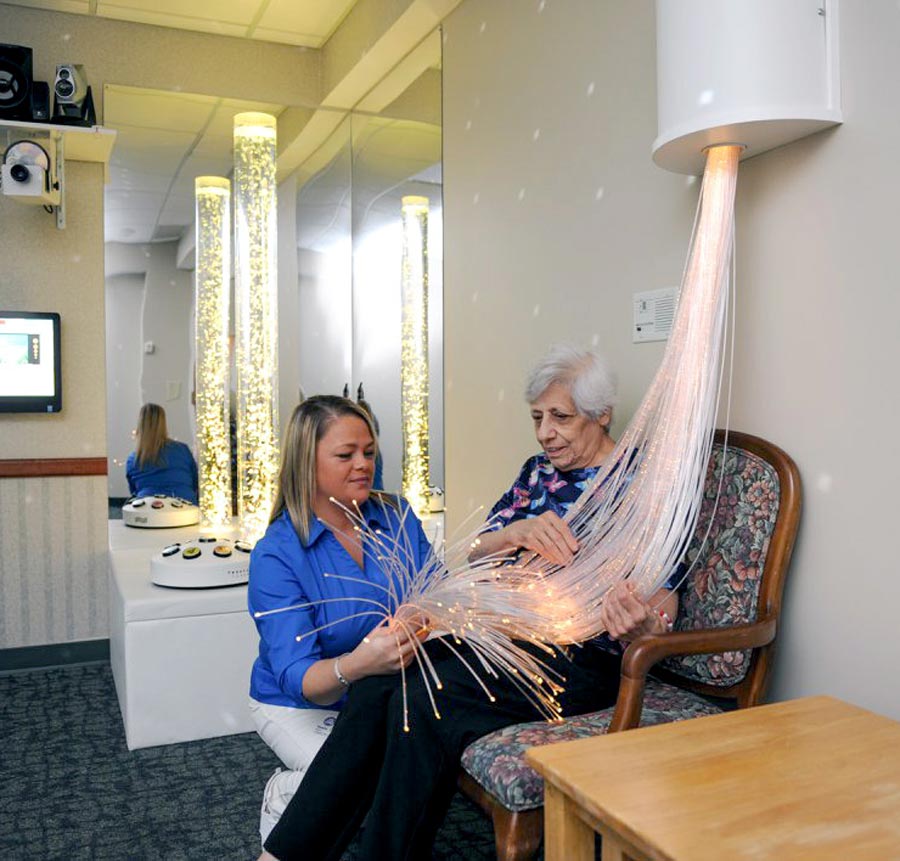 elderly resident using snoezelen room with nurse