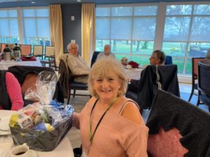 Image of blonde woman receiving a gift basket