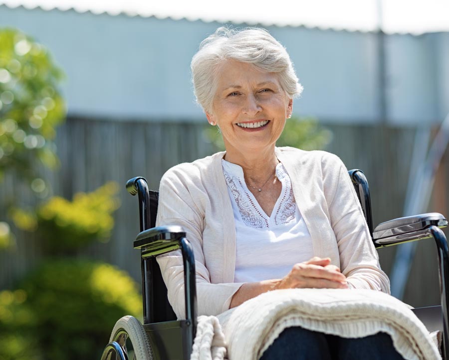 older woman in wheelchair smiling