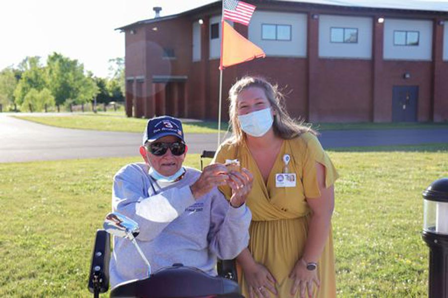 masonic care community team member posing with resident outside