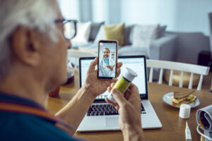 Man talking to doctor on phone about his meds